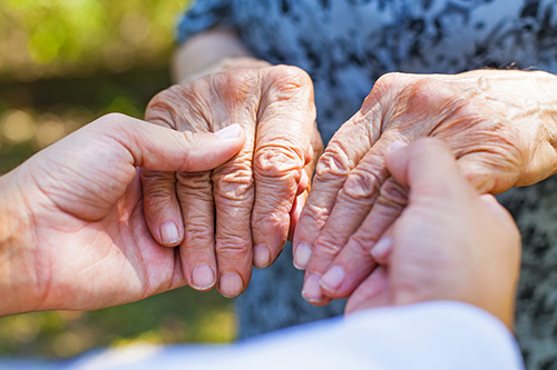 elderly_woman_holding_hands_with_nurse